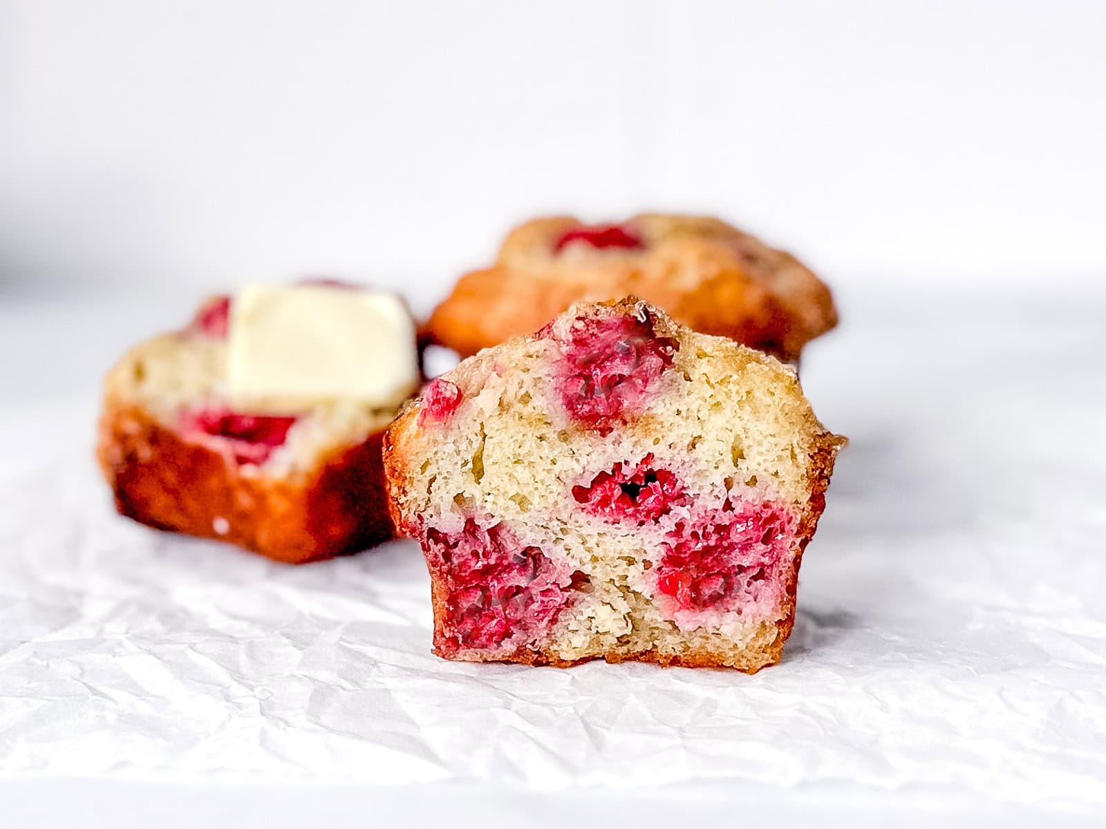 A raspberry banana muffin on a white background.