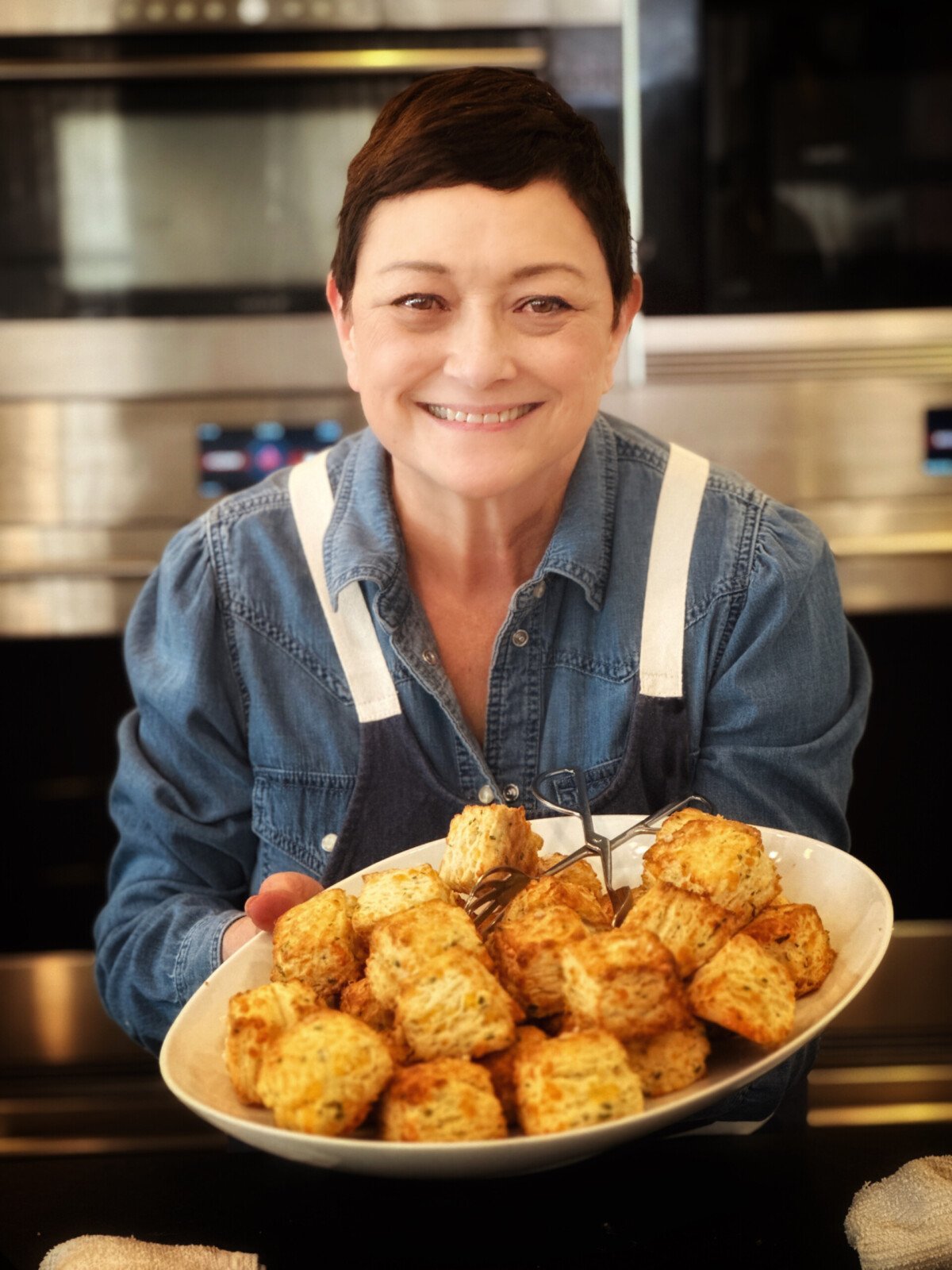 Cynthia holding a platter of biscuits.