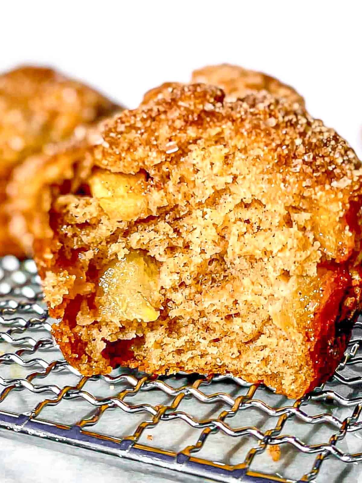 Apple cinnamon crunch muffins on a wire rack.