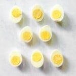 Sliced boiled eggs on marble background.