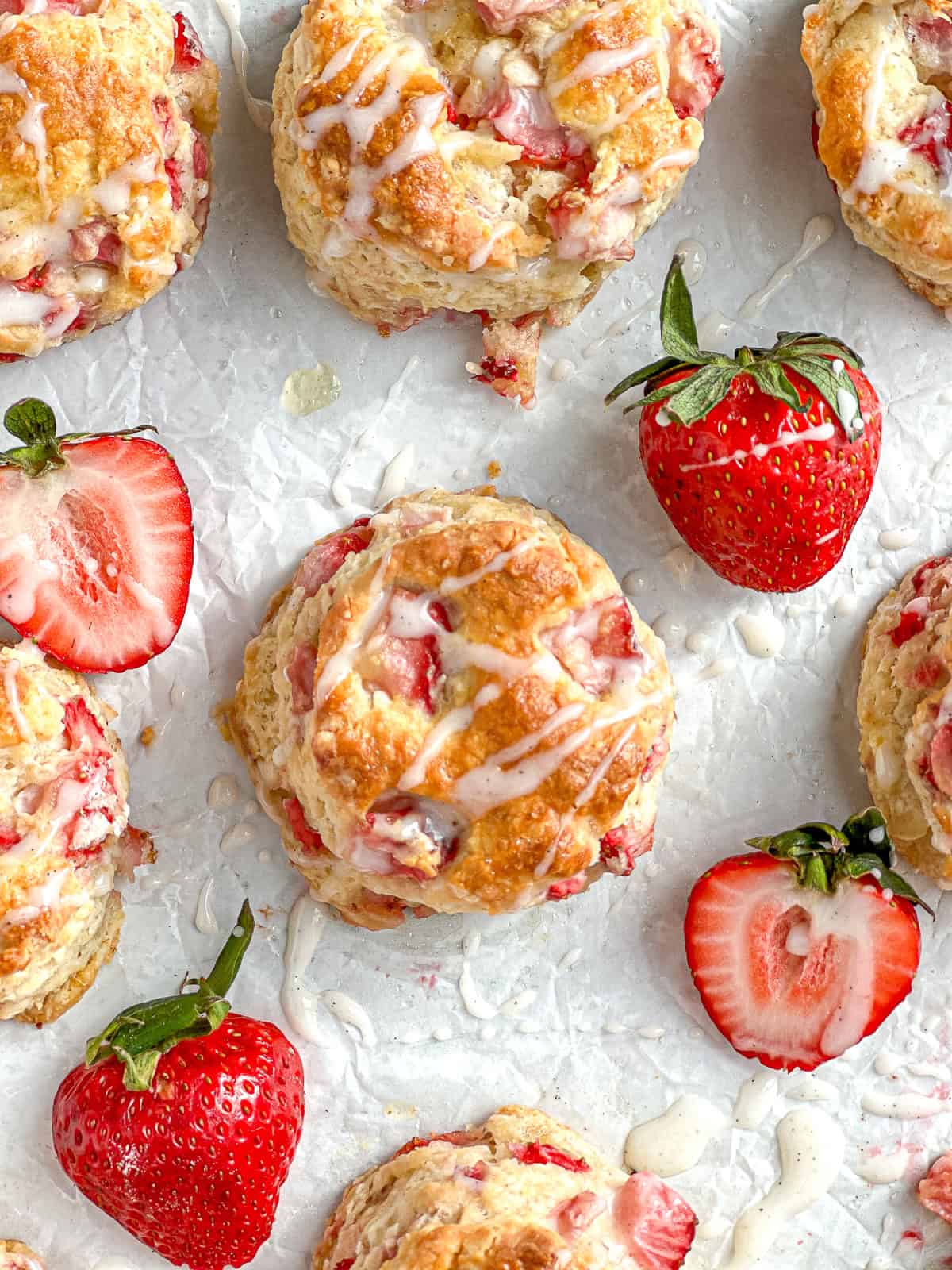 Vanilla glazed strawberry biscuits on a white napkin.