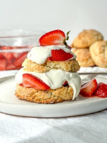 Horizontal image of biscuit strawberry shortcake on a white plate.
