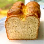 A sliced open brioche bread loaf in a sunny window.