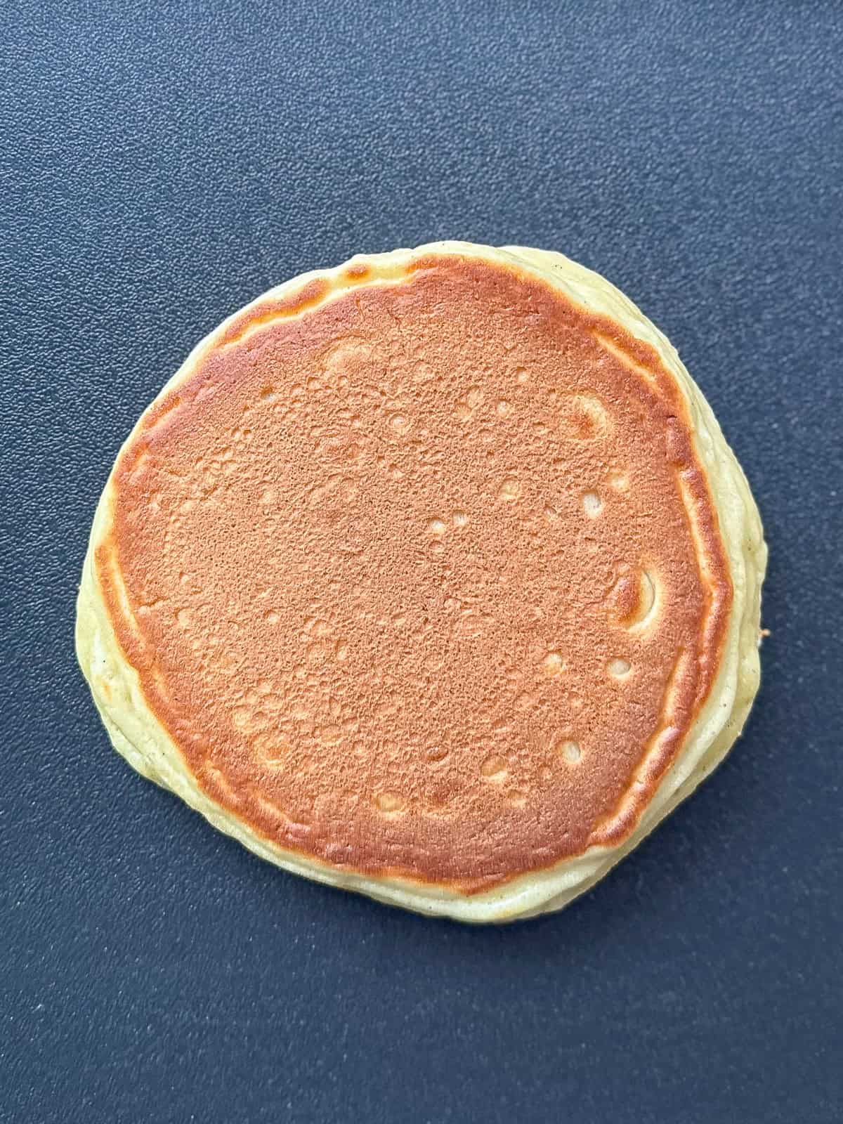 Flipped over pancake on nonstick pan.