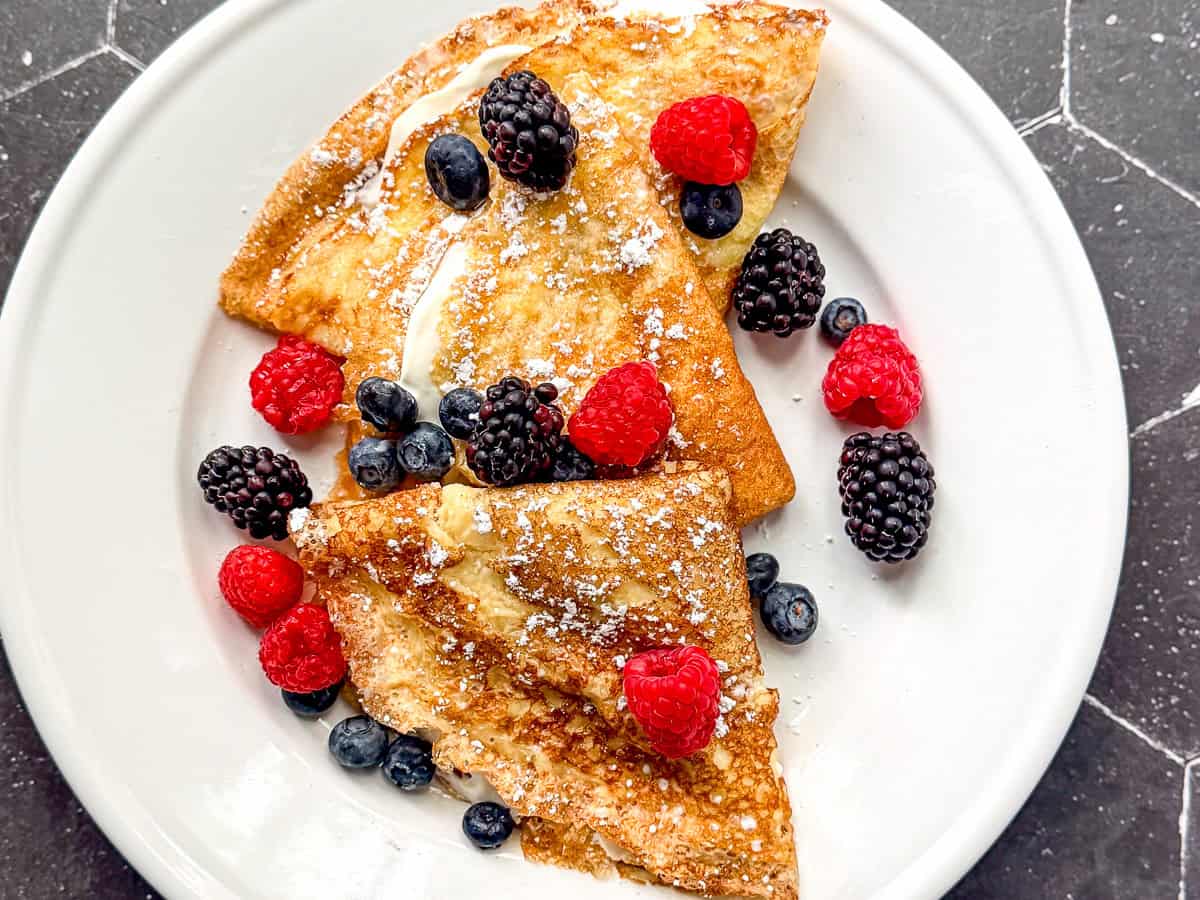 Crêpes on a plate with fresh berries.