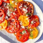 Marinated tomatoes on a grey plate.