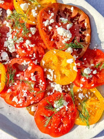 Marinated tomatoes on a grey plate.