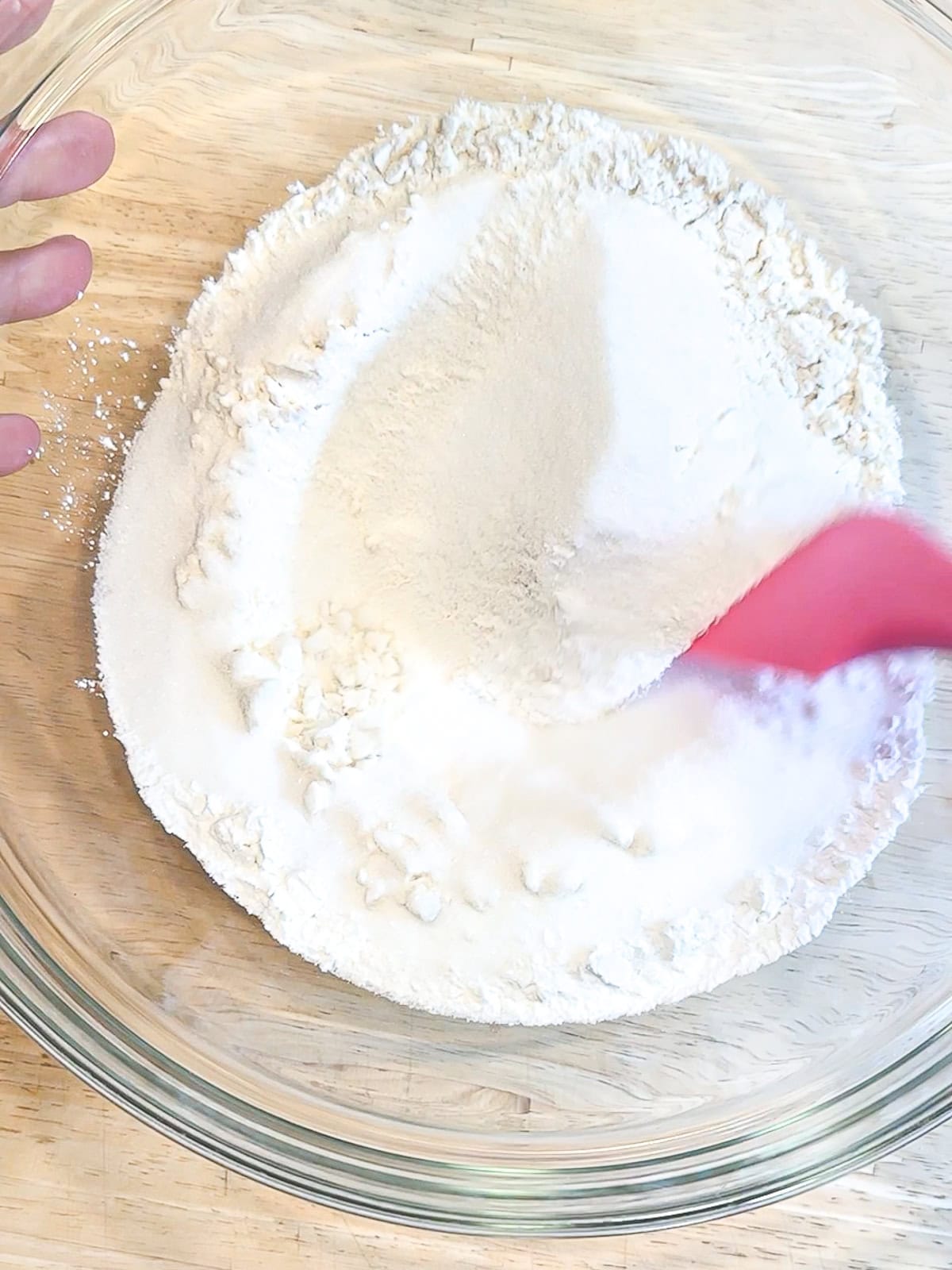 Mixing dry ingredients together to make coconut cake.