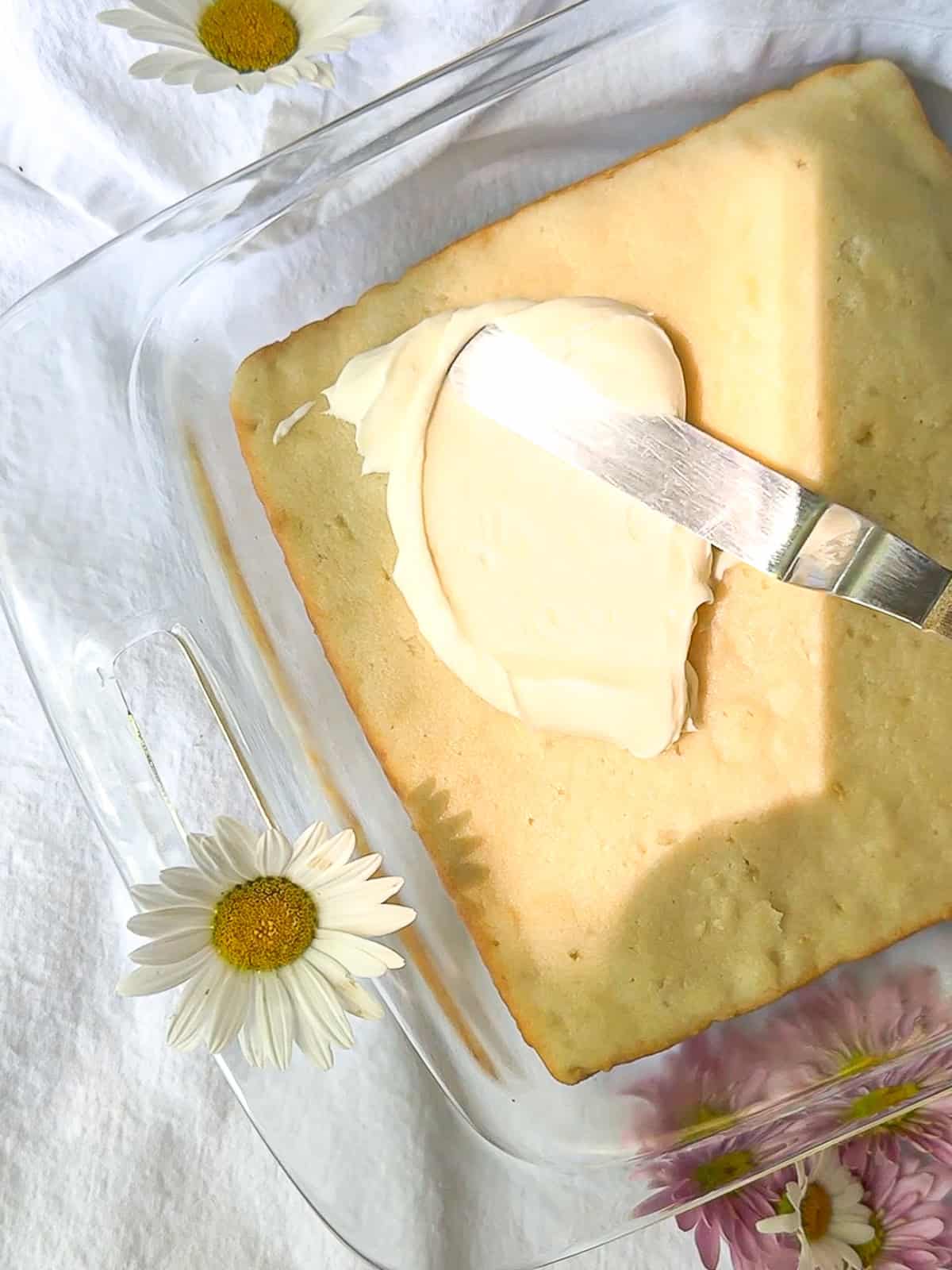 Frosting a coconut cake.