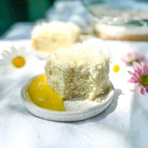 Coconut cake with lemon curd on a white plate.