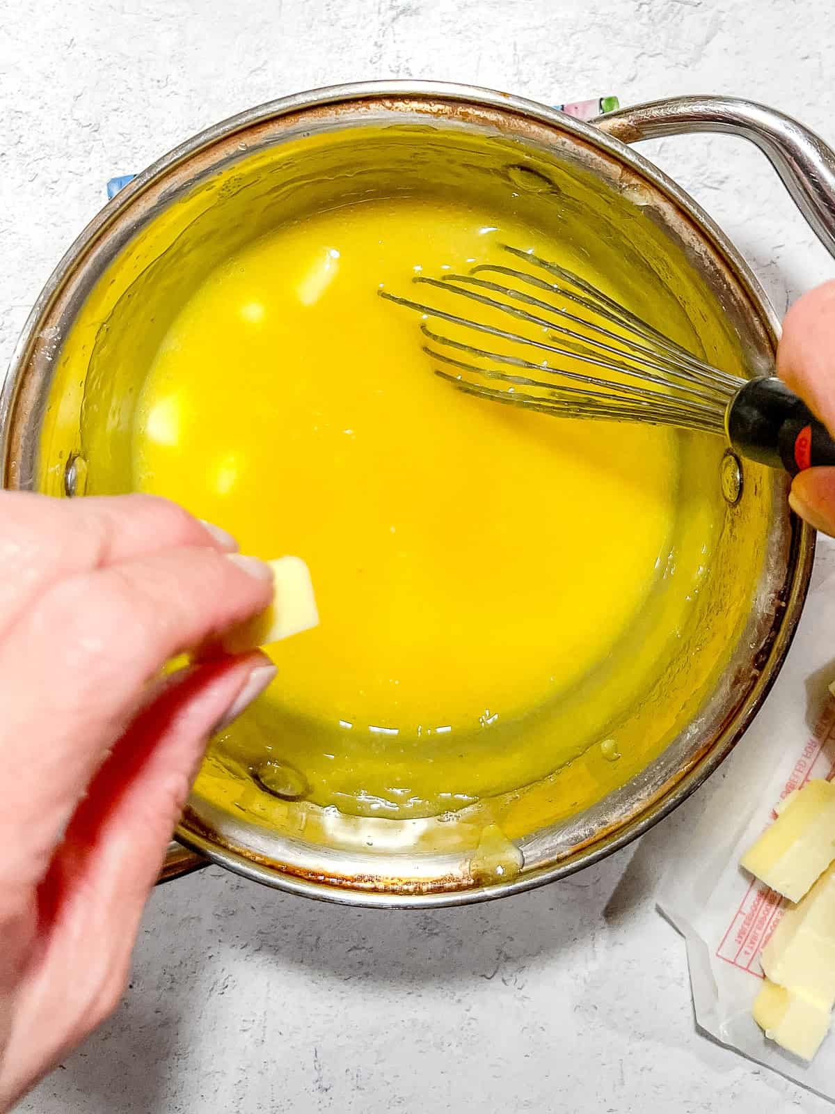 Whisking pieces of butter into easy lemon curd.