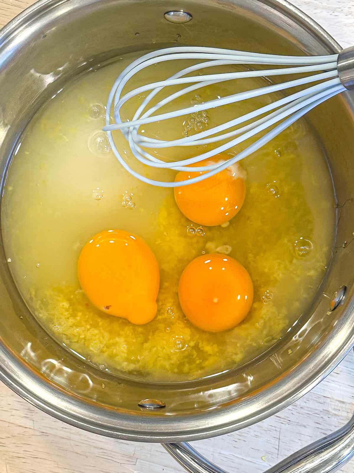 Adding all of the lemon curd ingredients to a small saucepan.