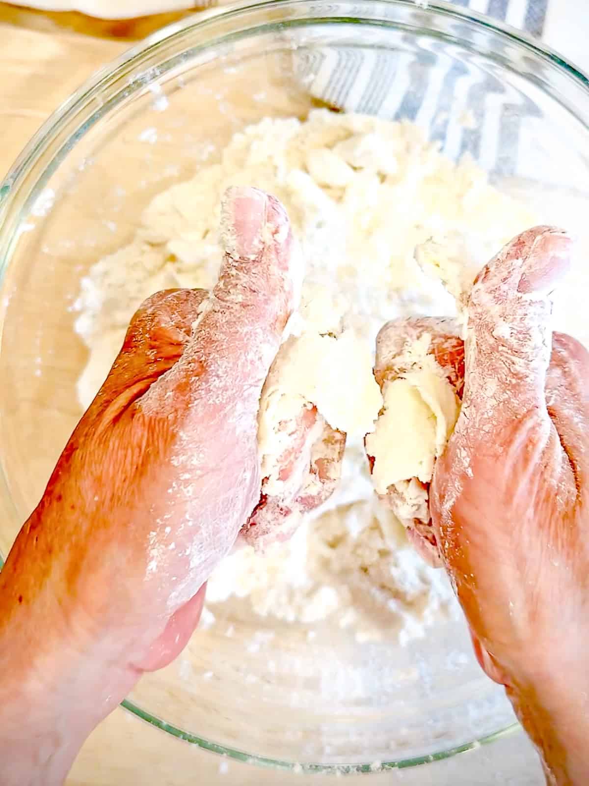 Cutting butter into dry ingredients for biscuits.