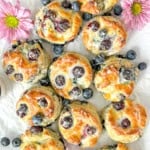 Glazed blueberry biscuits on a white background.