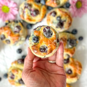 Author holding a glazed blueberry biscuit.