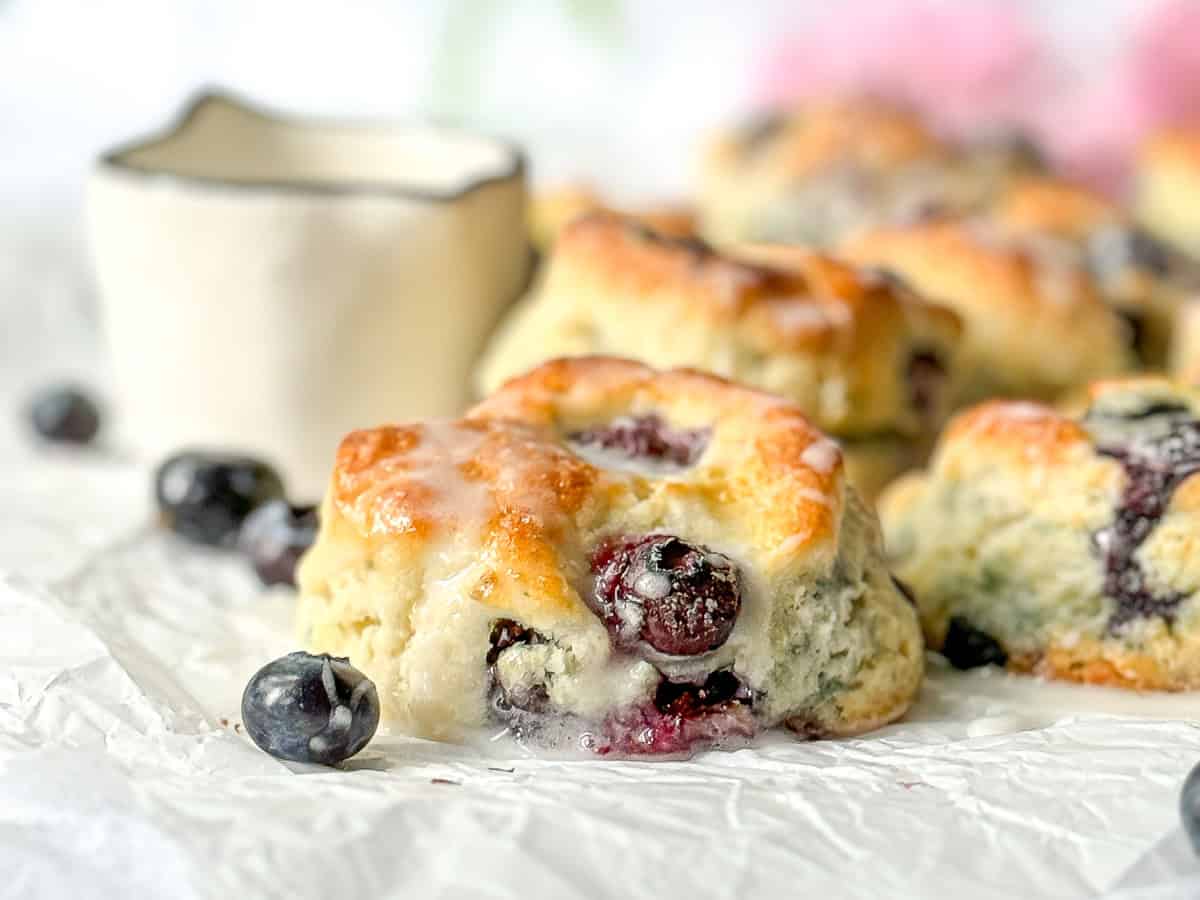 Close-up of a glazed blueberry biscuit.