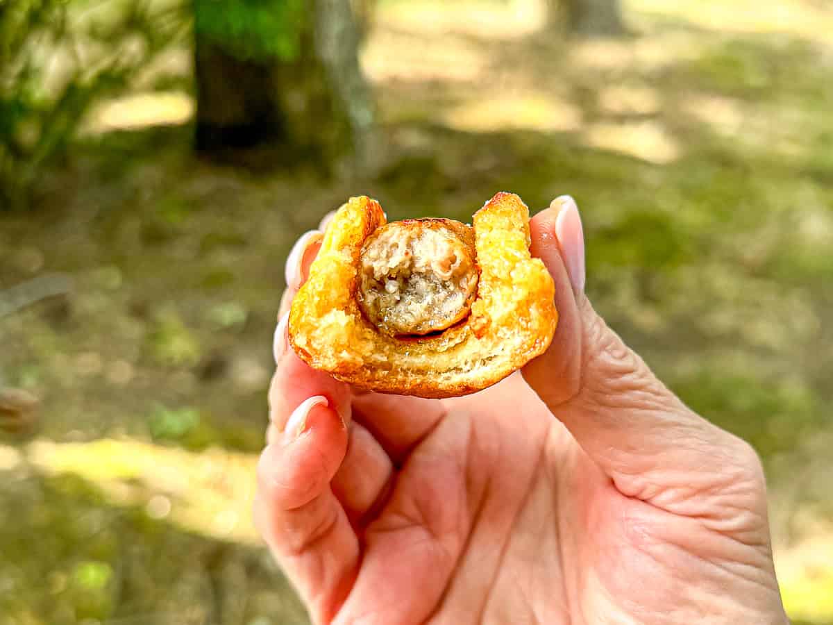 Hawaiian bread French toast wrapped around a piece of sausage.