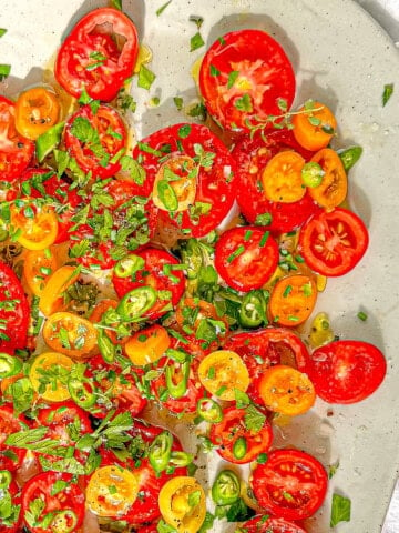 Marinated tomatoes on a green platter.