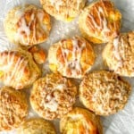 Peach Biscuits with vanilla drizzle on parchment paper.