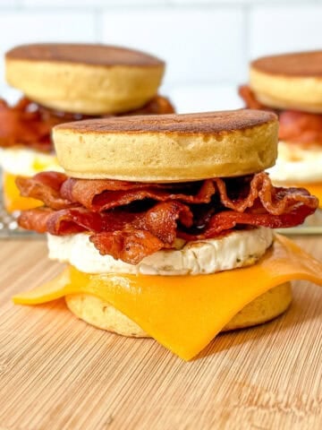 Three McGriddles on a wooden cutting board.