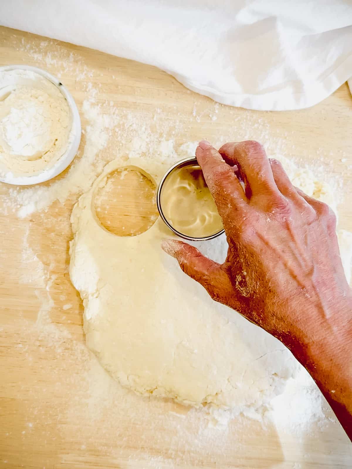 Using a biscuit cutter to cut our homemade biscuits.