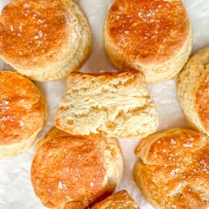 Fluffy homemade biscuits on parchment paper.