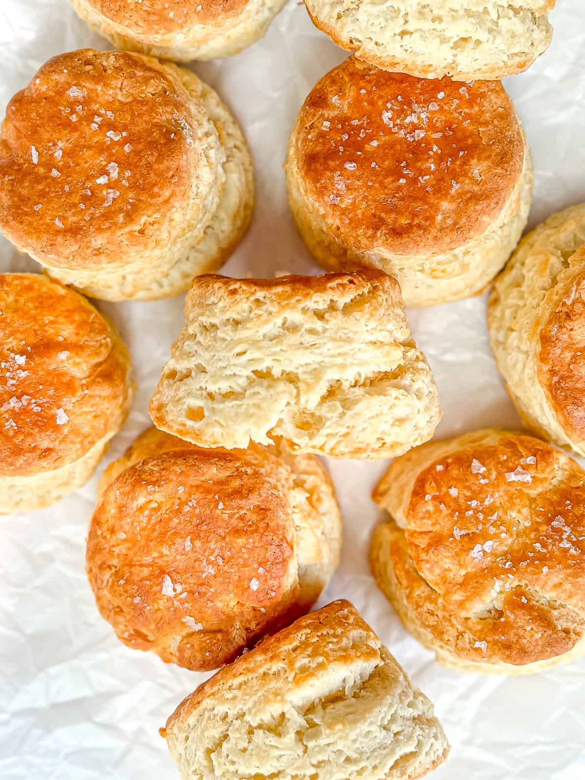 Fluffy homemade biscuits on parchment paper.