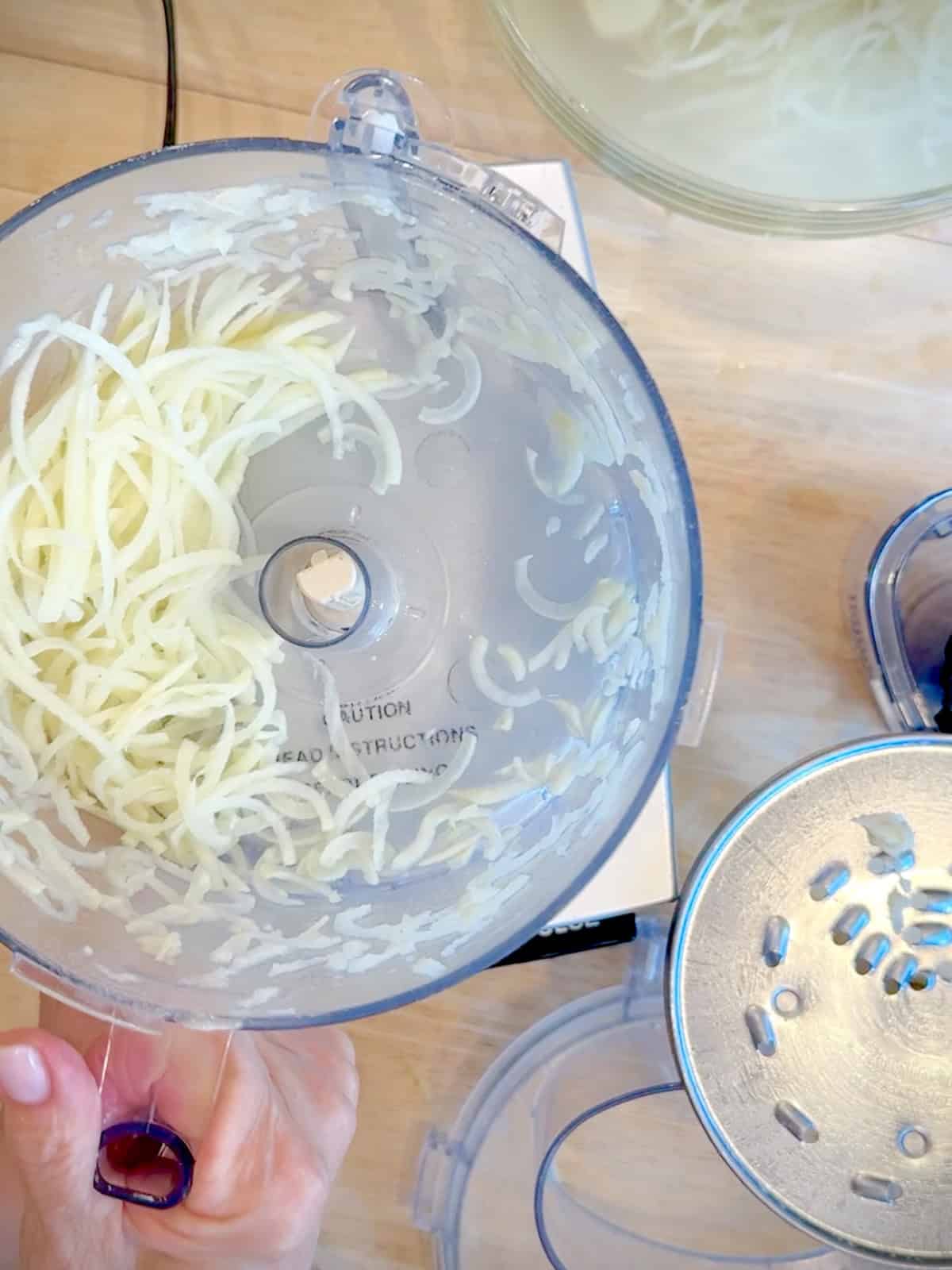 Shredded potatoes ina food processor.