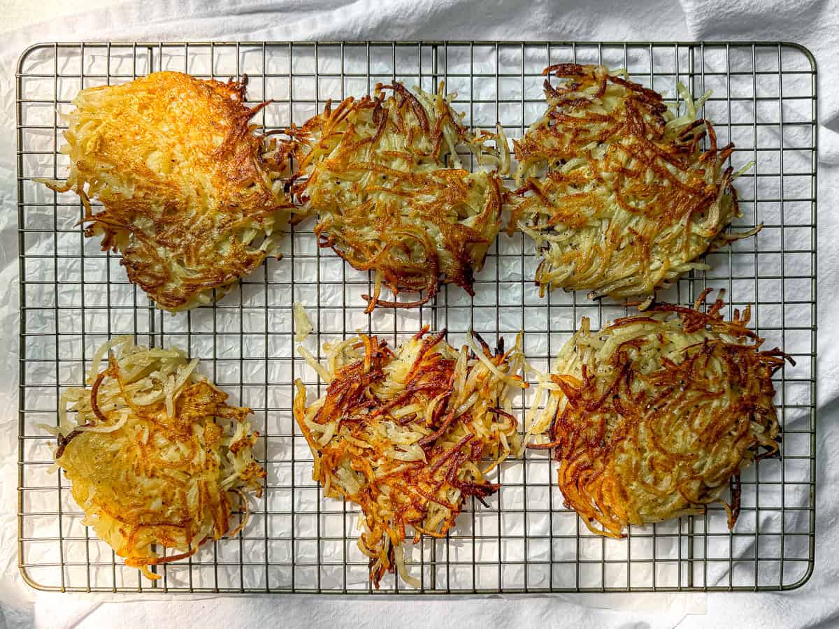 Hash brown patties on a wire rack.