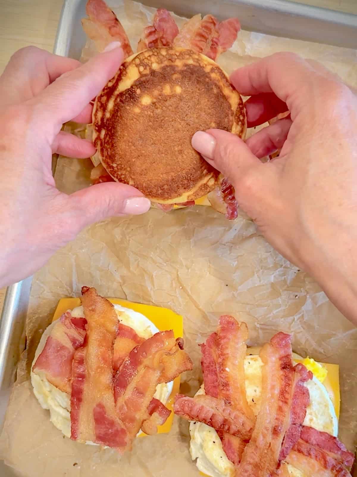 Making homemade McGriddles on a sheet pan lined with parchment paper.