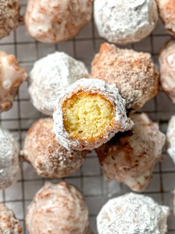 Donut holes on a wire rack.