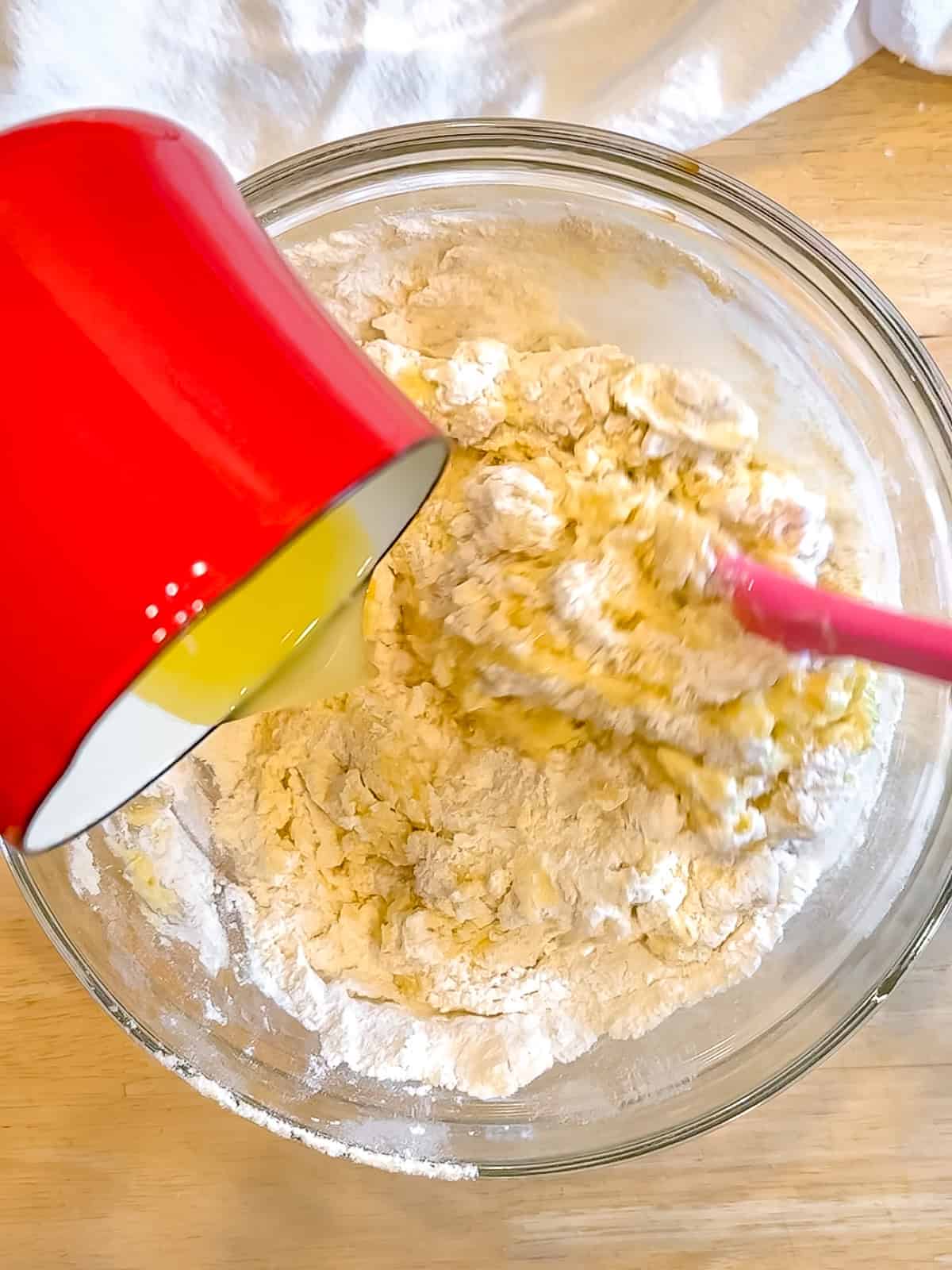 Drizzling and melted and cold butter to muffin batter.