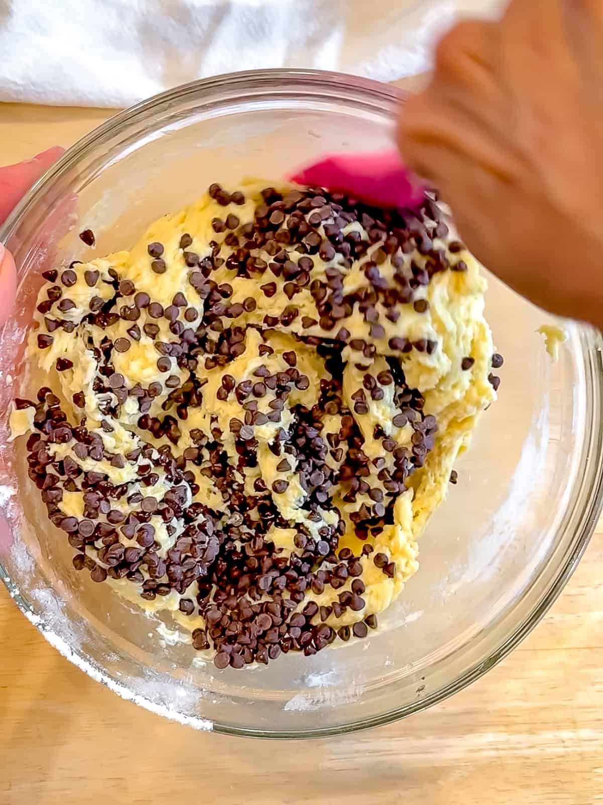 Folding chocolate chips into muffin batter.