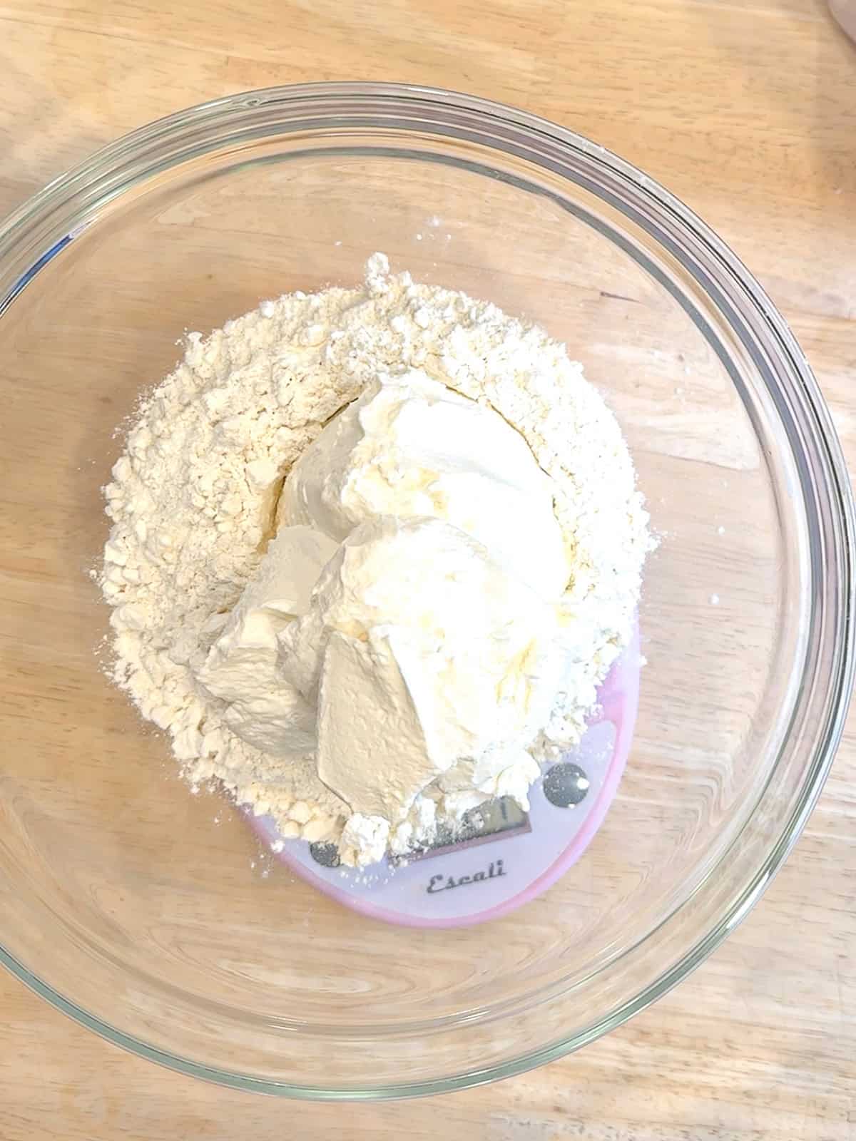 Ingredients for two ingredient dough in a glass bowl.