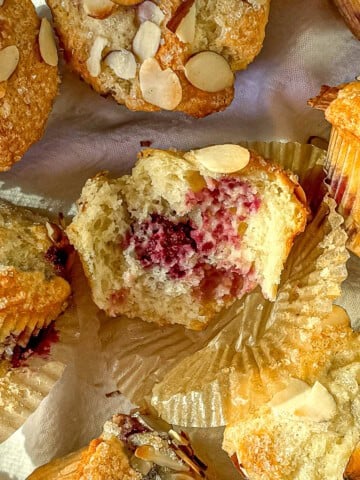 Blackberry almond muffins on a white background.