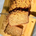 Close-up image of a slice of pumpkin spice banana bread with streusel topping.
