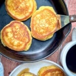 Southern hoecakes in a cast-iron pan with a cup of coffee next to it.