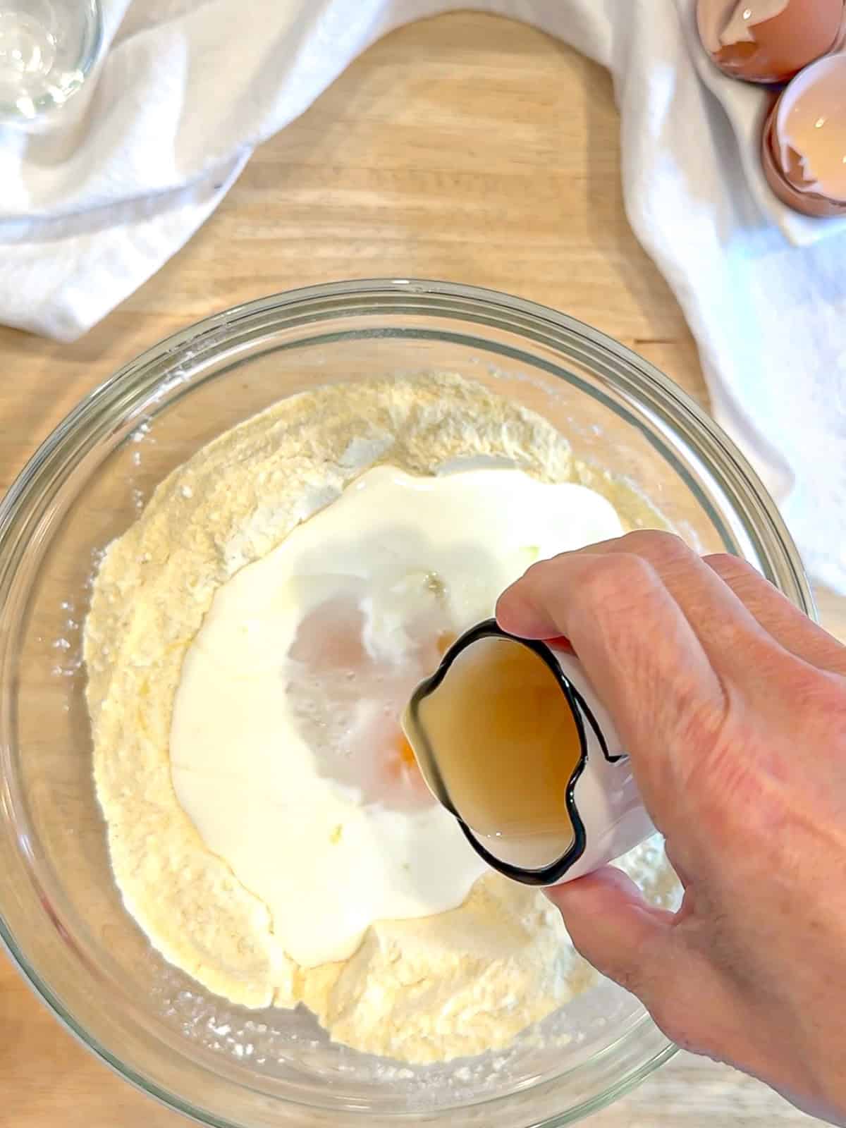 Adding wet ingredients into dry ingredients to make southern hoecakes.