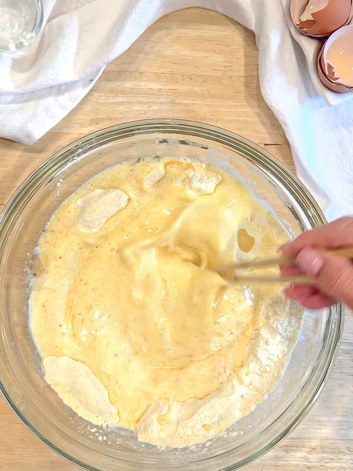 Mixing ingredients into dry ingredients to make southern hoecakes.