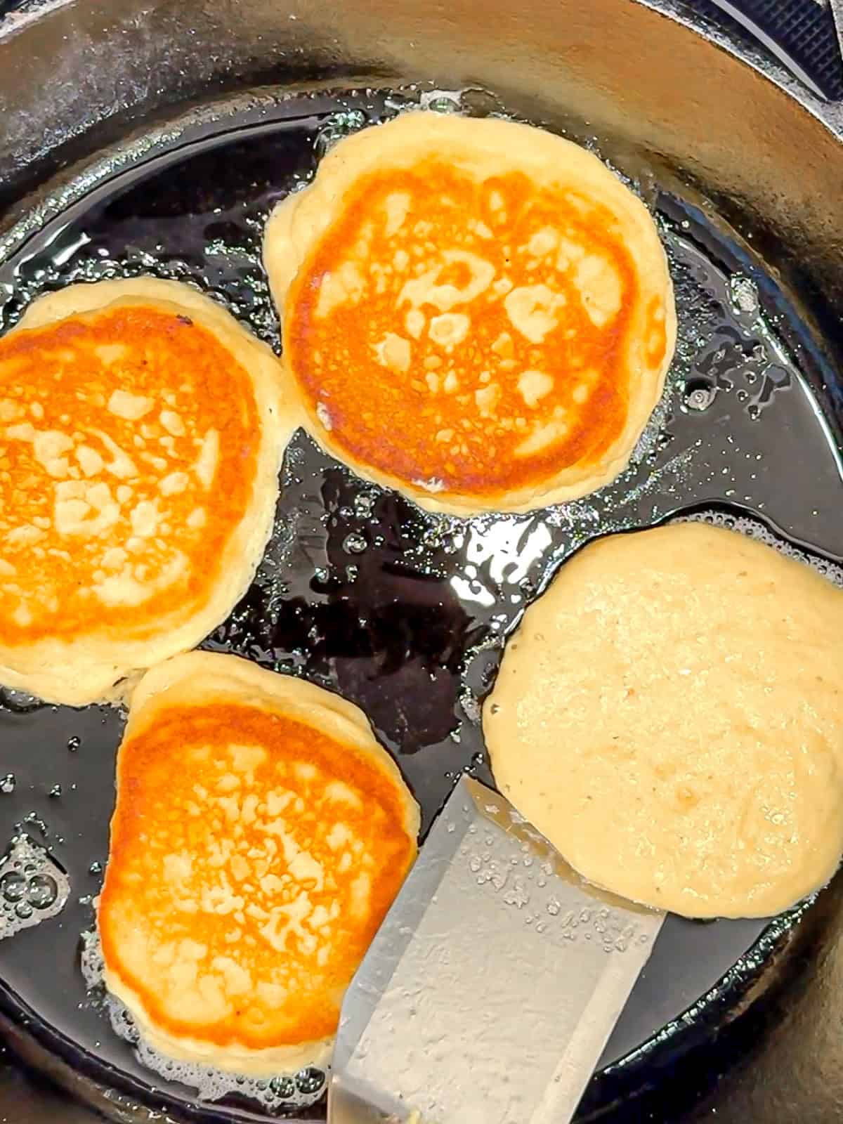 Flipping hoecakes in a cast-iron pan.