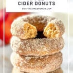 Pinterest image of a stack of baked apple cider donuts, the one on top with a bite taken out.