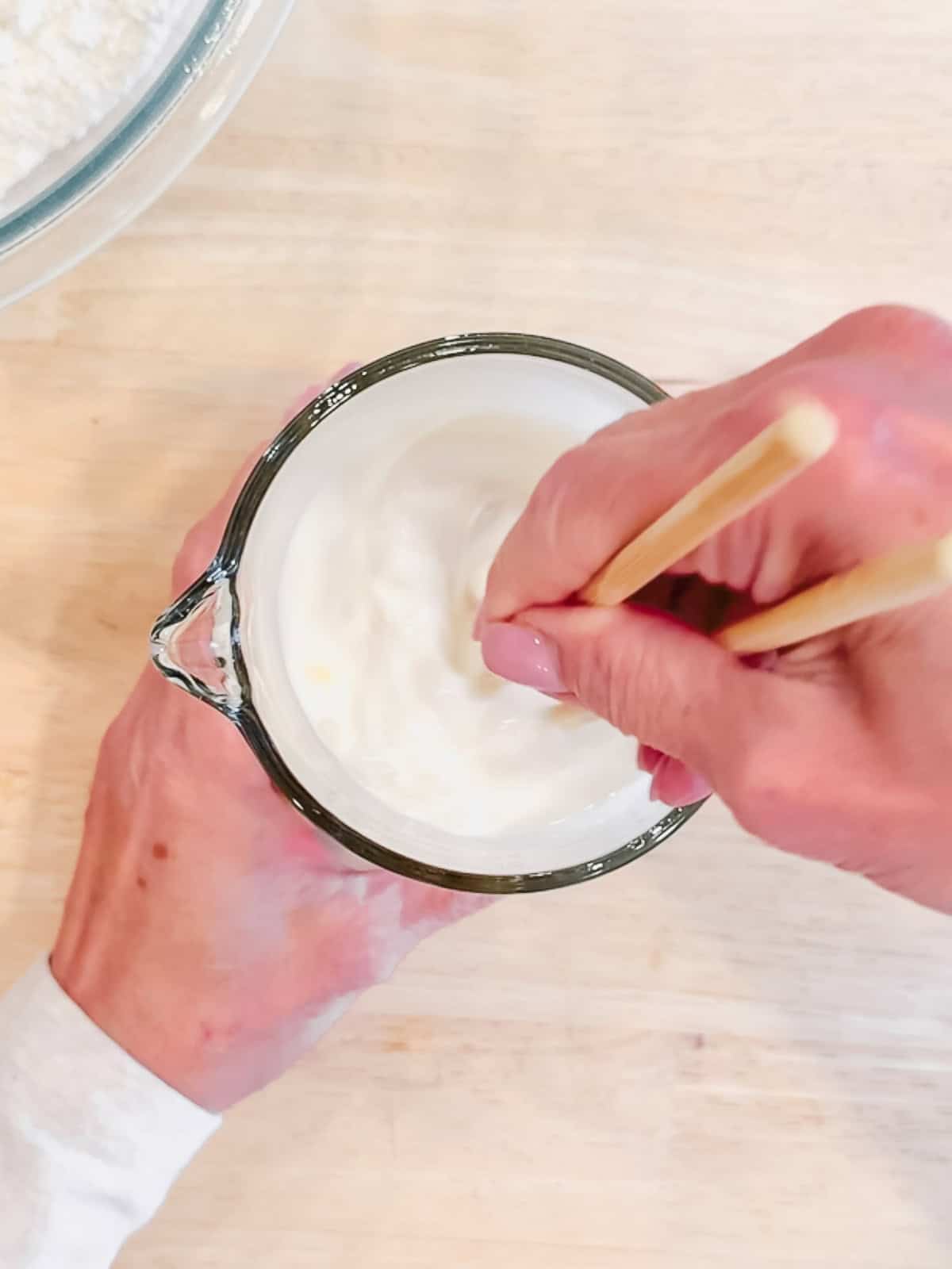 Whisking together, wet ingredients for pancake batter.