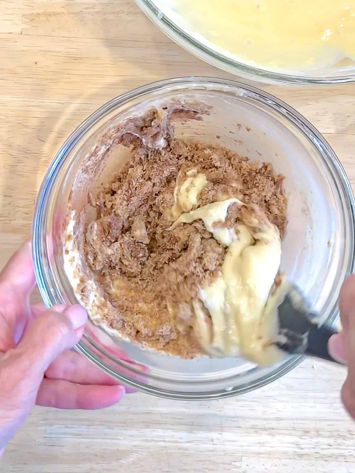 Mixing the cinnamon roll swirl in a glass bowl.