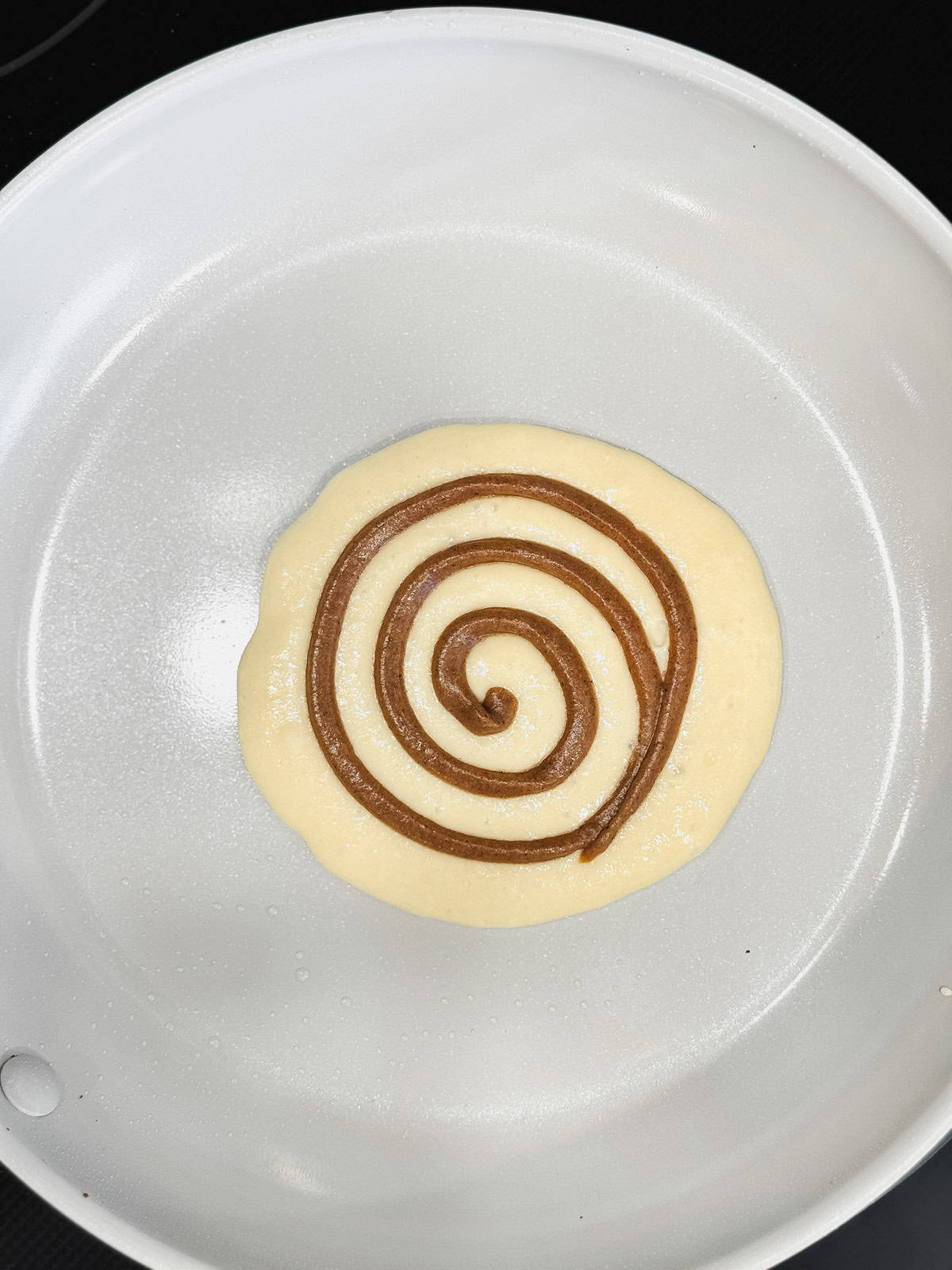 Adding a cinnamon sugar pancake swirl to the top of the pancake.