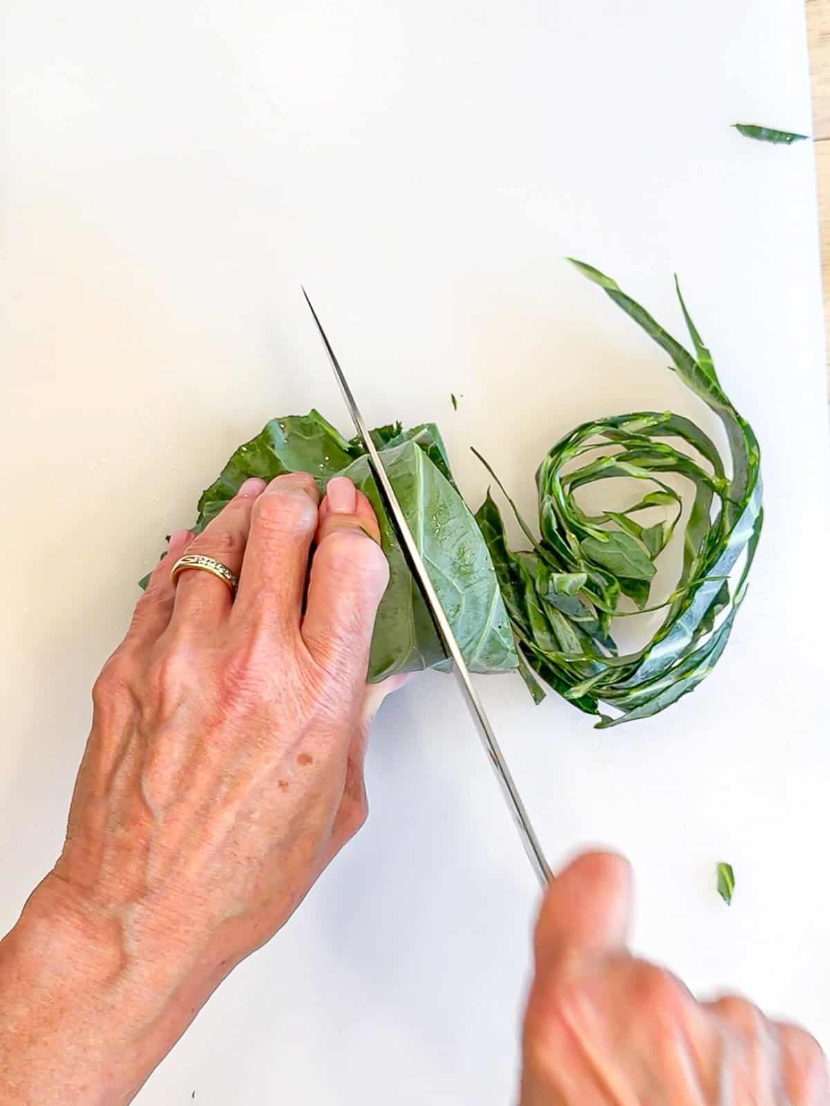 Slicing ribbons of collard greens.