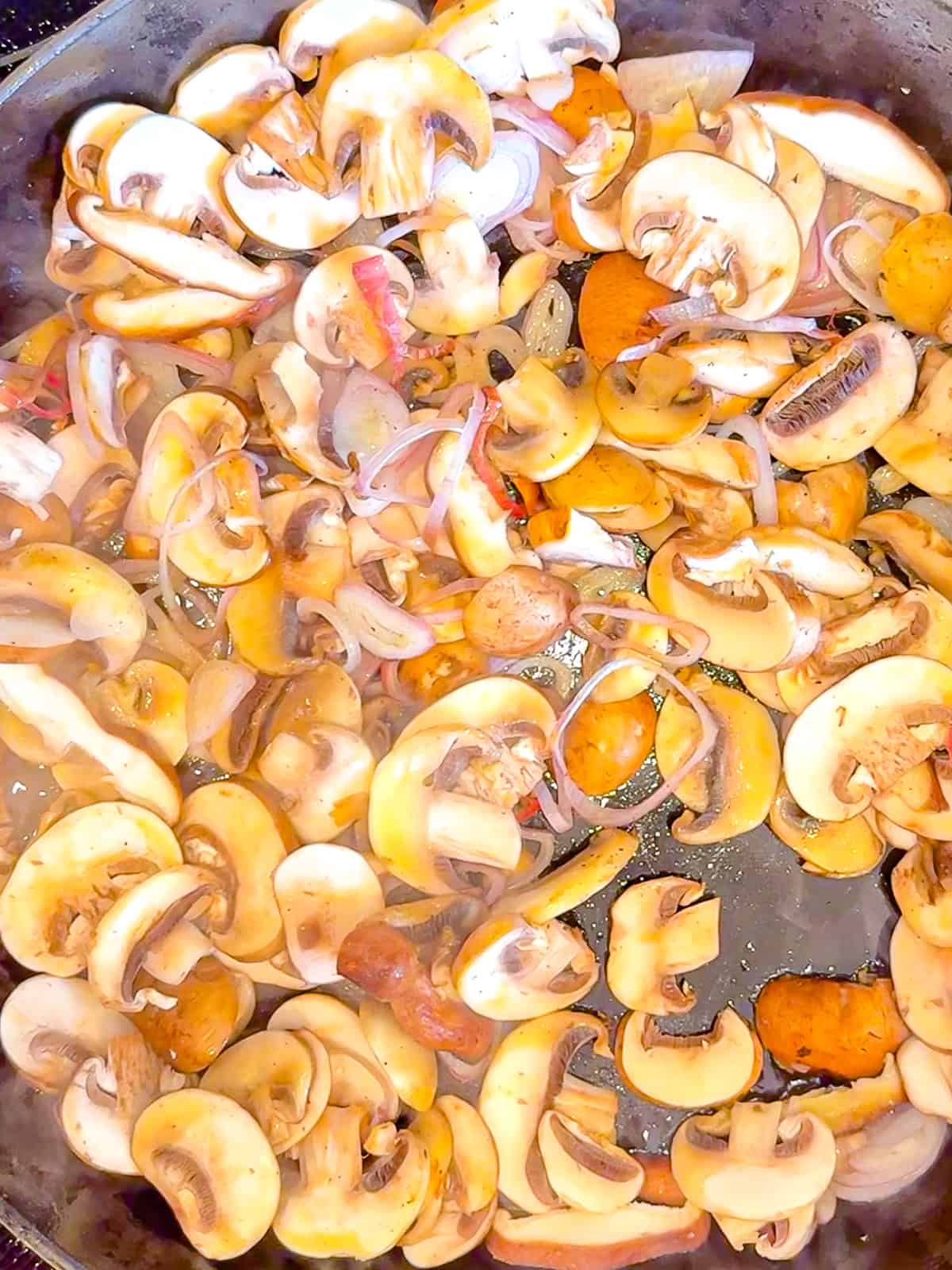 Adding mushrooms and shallots to melted butter and olive oil in a skillet