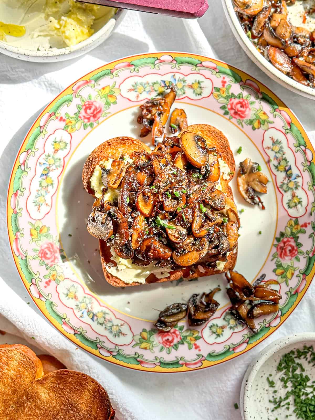 Mushroom toast on a flowered plate.