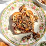 Mushroom toast on a flowered plate.