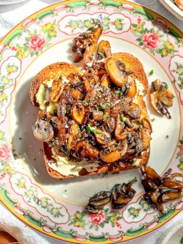 Mushroom toast on a flowered plate.