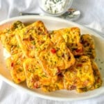 Potato cheddar and chive egg bites on a white platter.